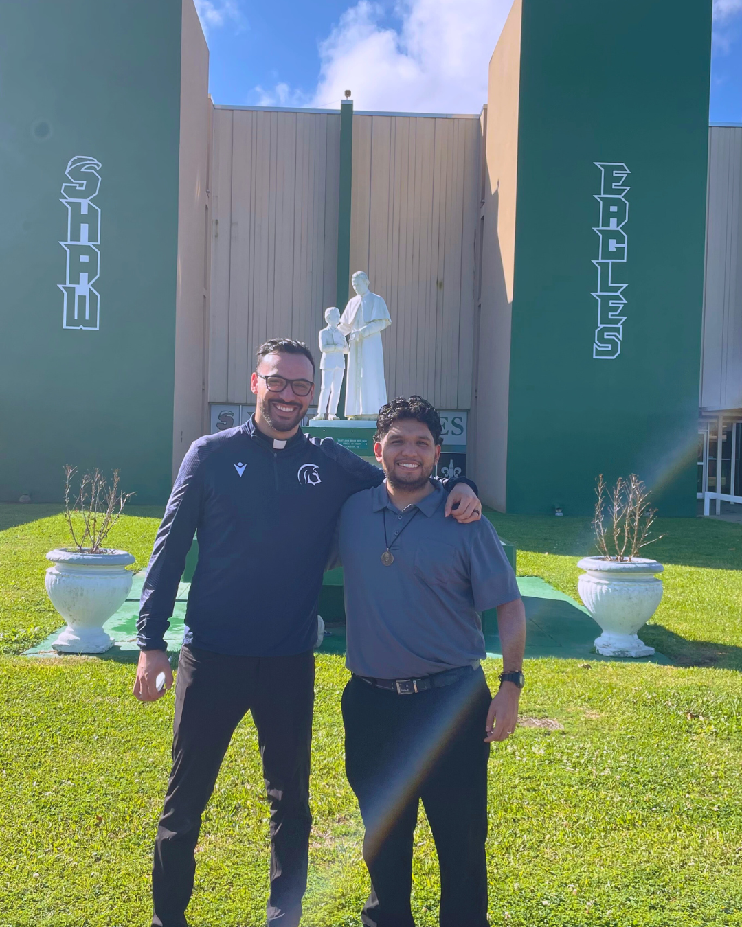 Bros. Lorenzo and Carlos pose on the front lawn of Archbishop Shaw.