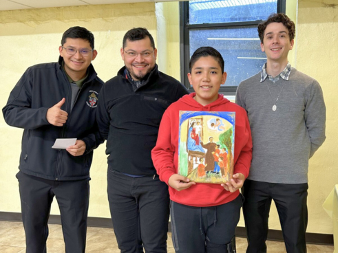  One of the winners of the Don Bosco Art Contest displays his work.