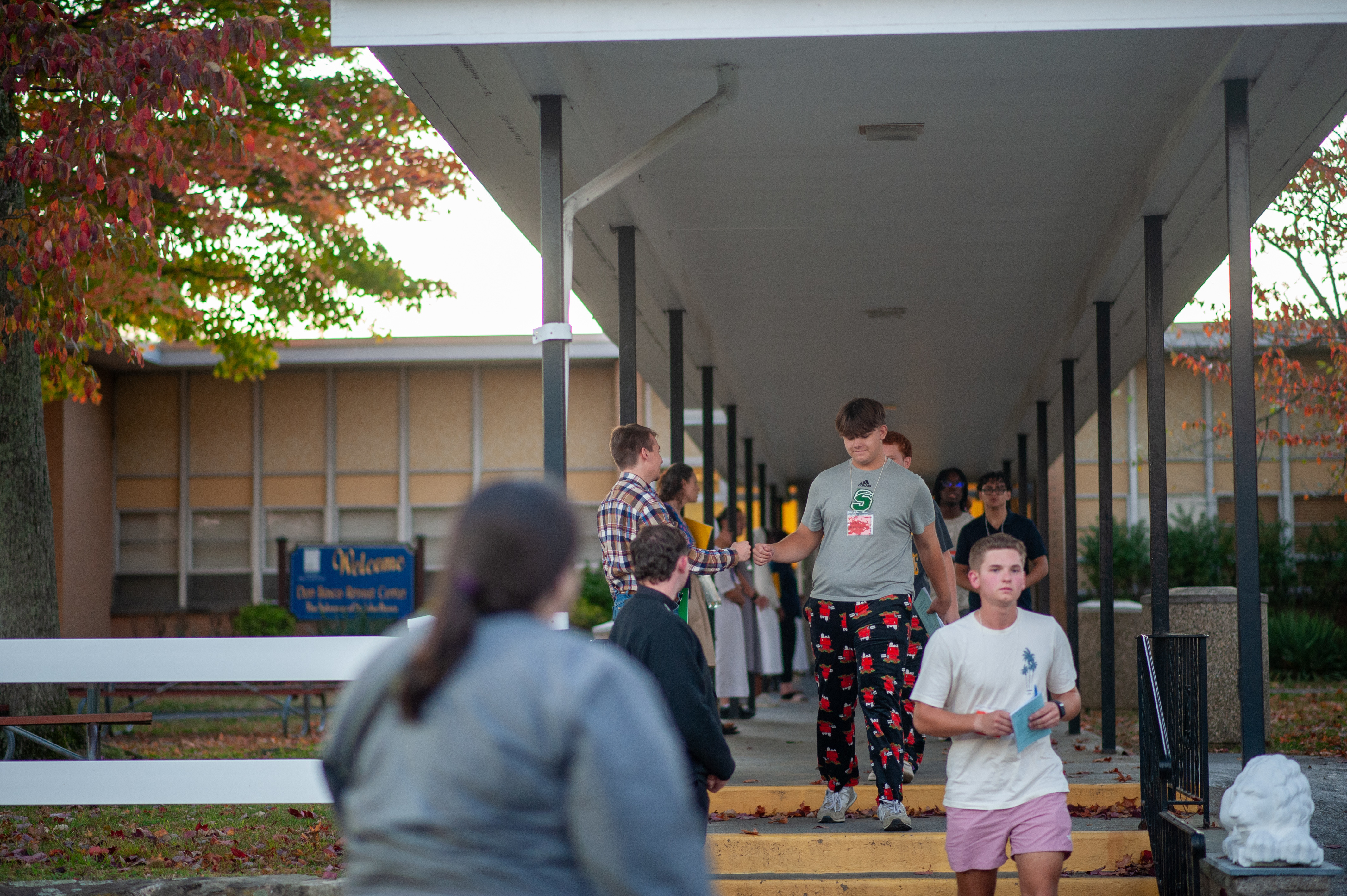Students are accompanied by the adult chaperones as they exit the retreat center.