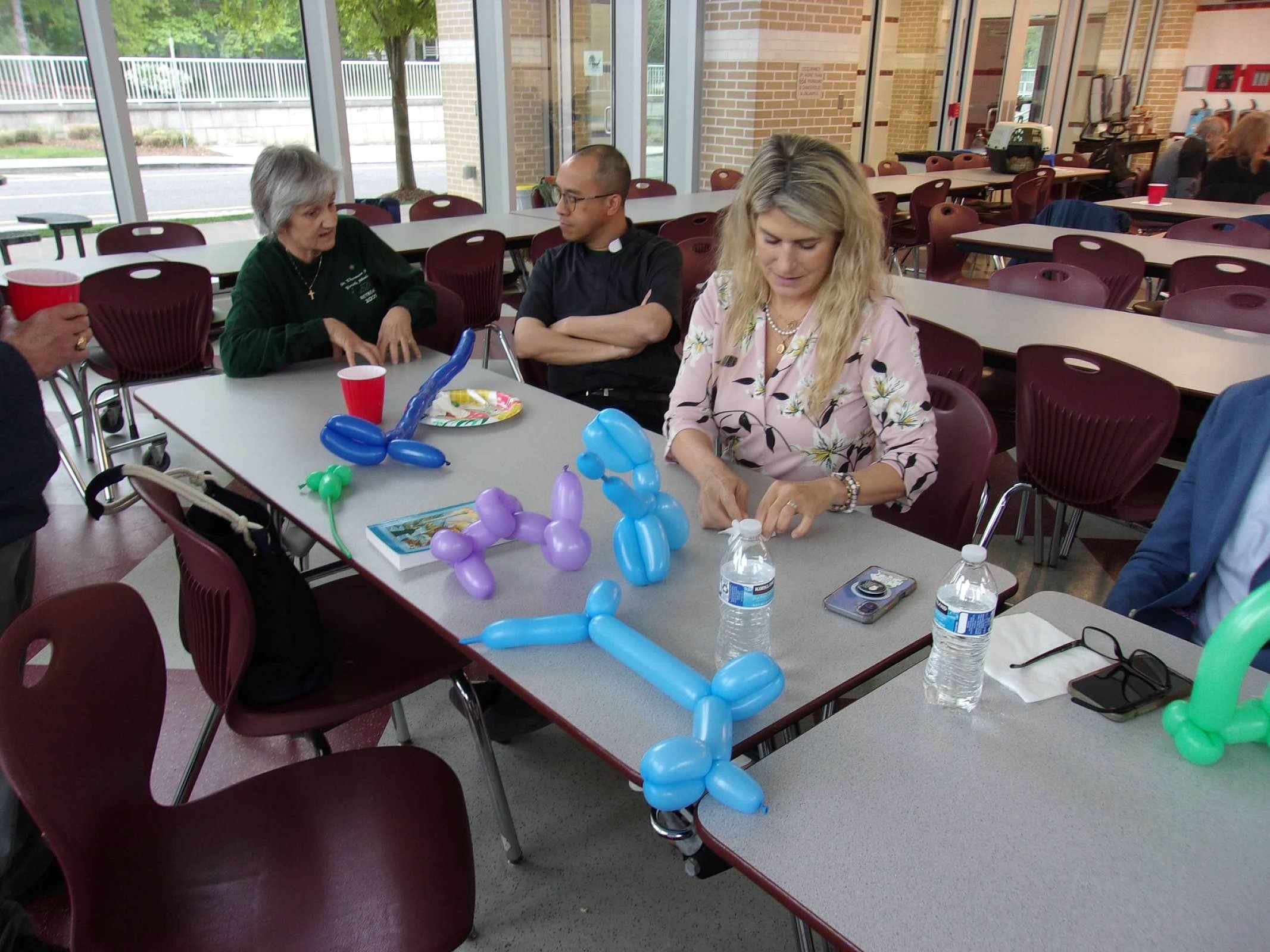 Salesian Cooperator Cindy Wooldridge makes balloon animals.