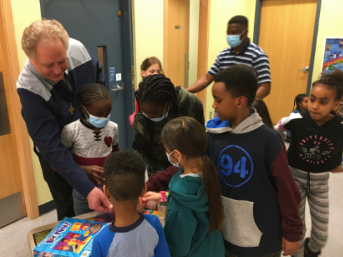 Fr. Tim with Kids in Edmonton