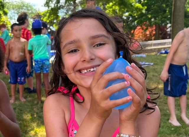 New Rochelle: A camper prepares to use her water balloon.
