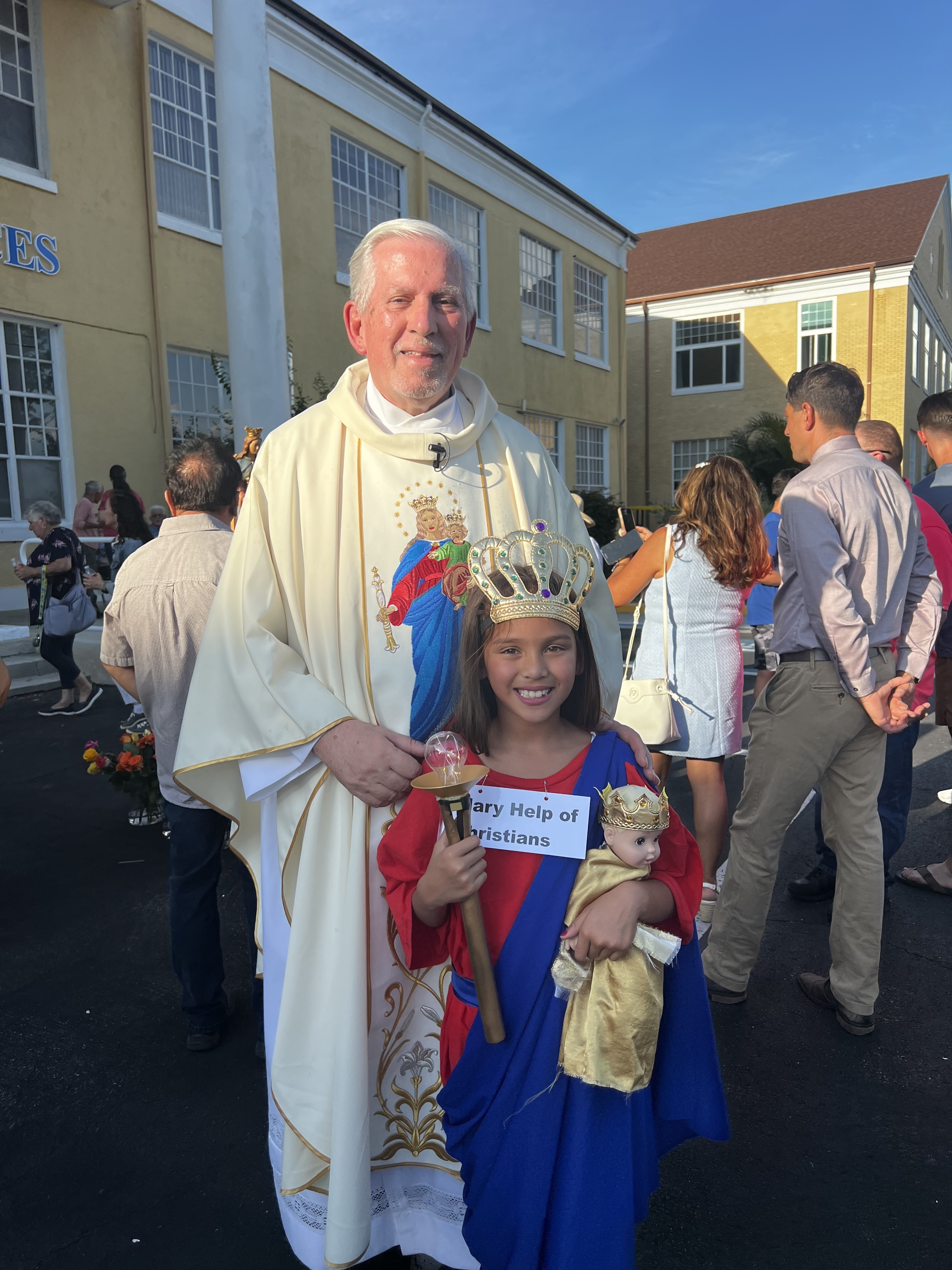Fr. John Serio, SDB, and a young Tampa girl dressed as Mary Help of Christians during the festivities