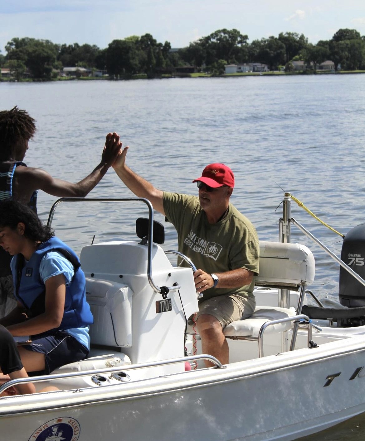 Jerry and a Tampa youth high-five while out on the lake.