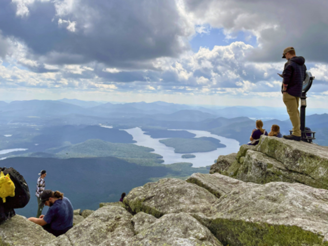Visitors enjoy the view of Lake Placid from Whiteface Mountain