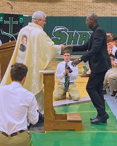 Bro. Pascal Mukuye renews his profession before Fr. Steven Ryan.