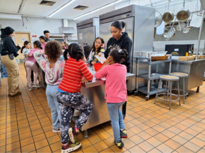 Led by Brenda and two staff members, Club members bake together.