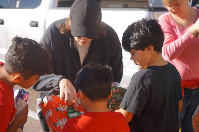 Tampa: An outreach crew members distributes presents to local youths. 