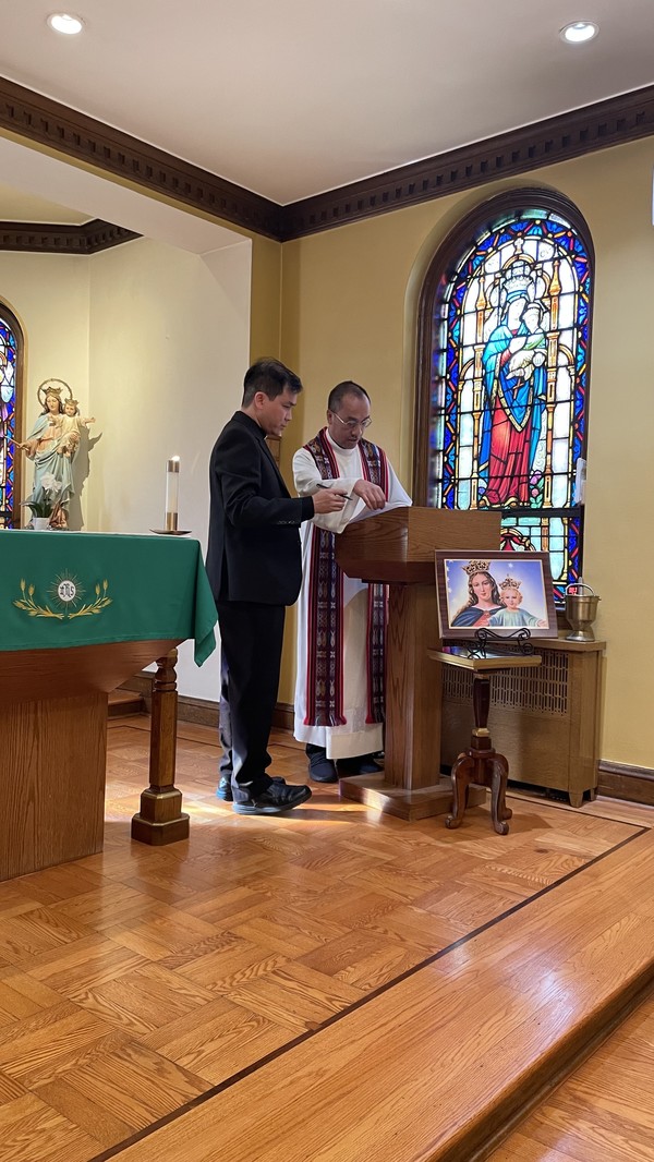 Provincial Fr. Dominic (right) installs Fr. Ky (left) as the new director of the Orange community.