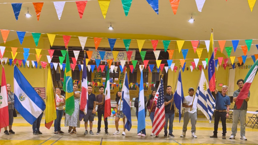 Port Chester Salesian Family members hold various flags during St. John Bosco Parish’s Multicultural Day celebration.