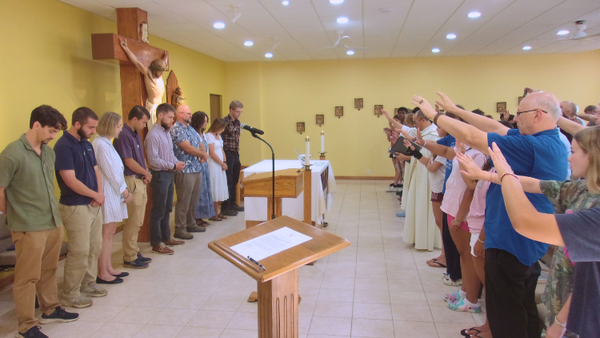 Salesians and Gospel Roads participants join Fr. Dominic in blessing the SLMs.