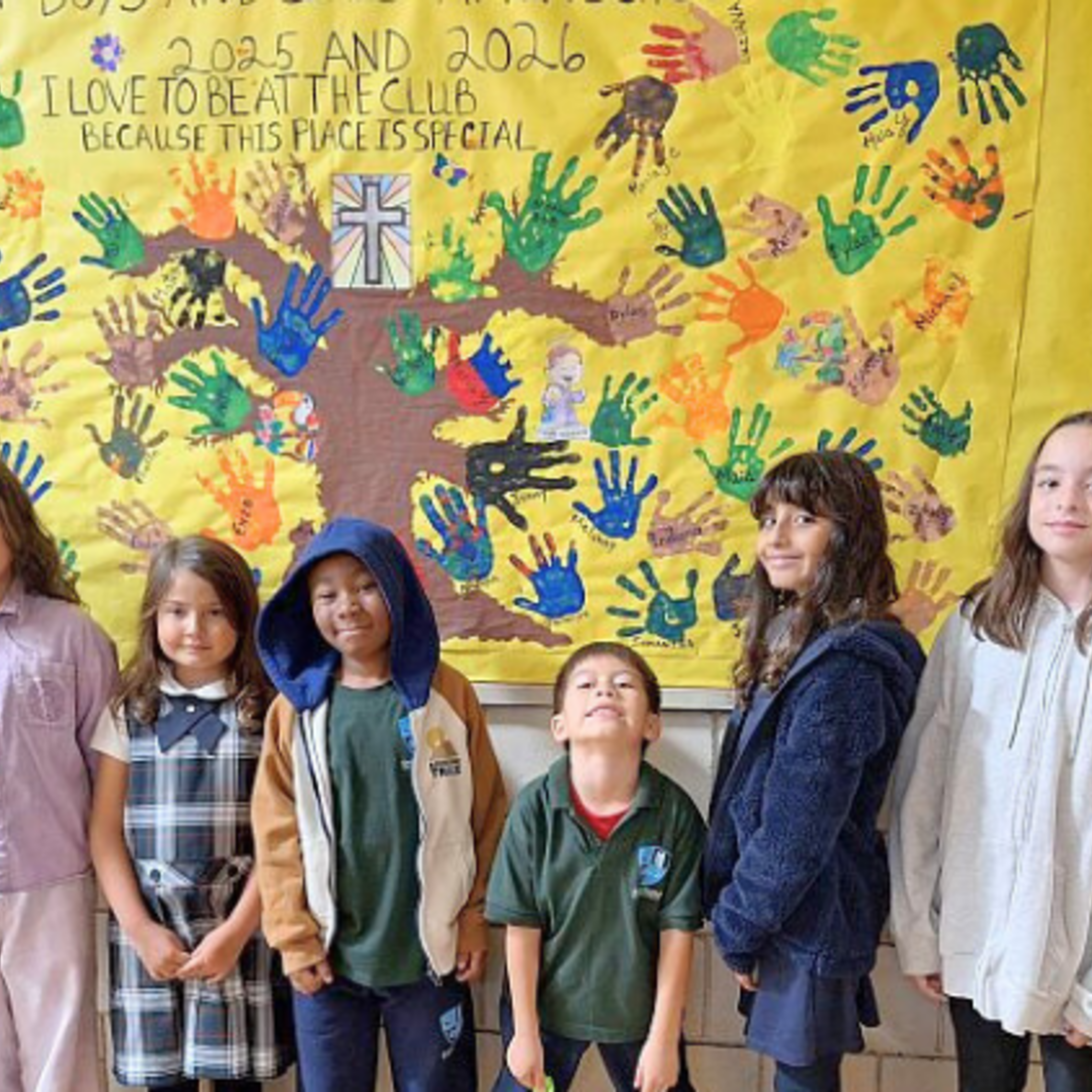 Club members pose with one of the bulletin boards. | Credit: Bro. Bob Metell, SDB East Boston: October 2025 News