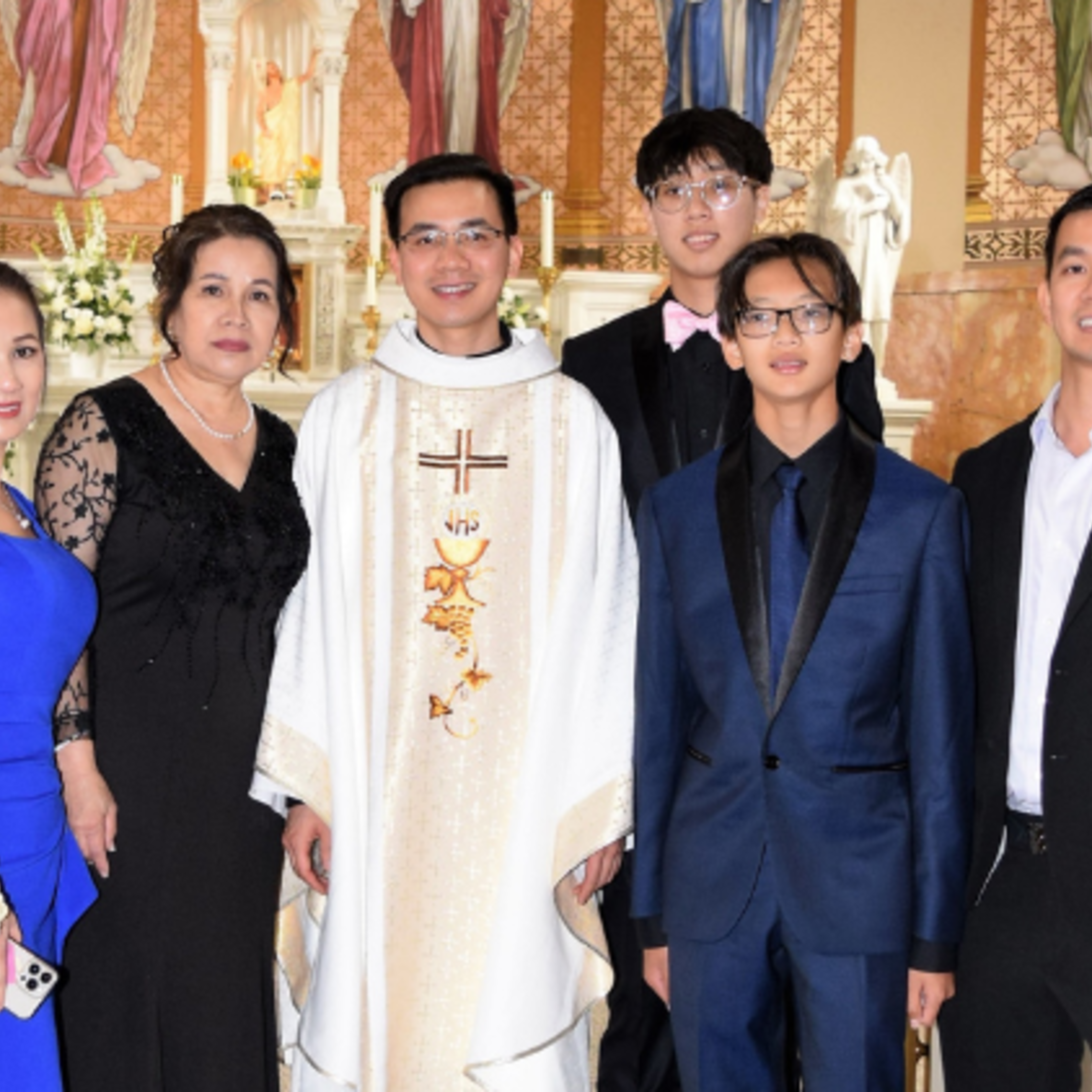 Newly ordained Fr. Ky Nguyen, SDB, and his family