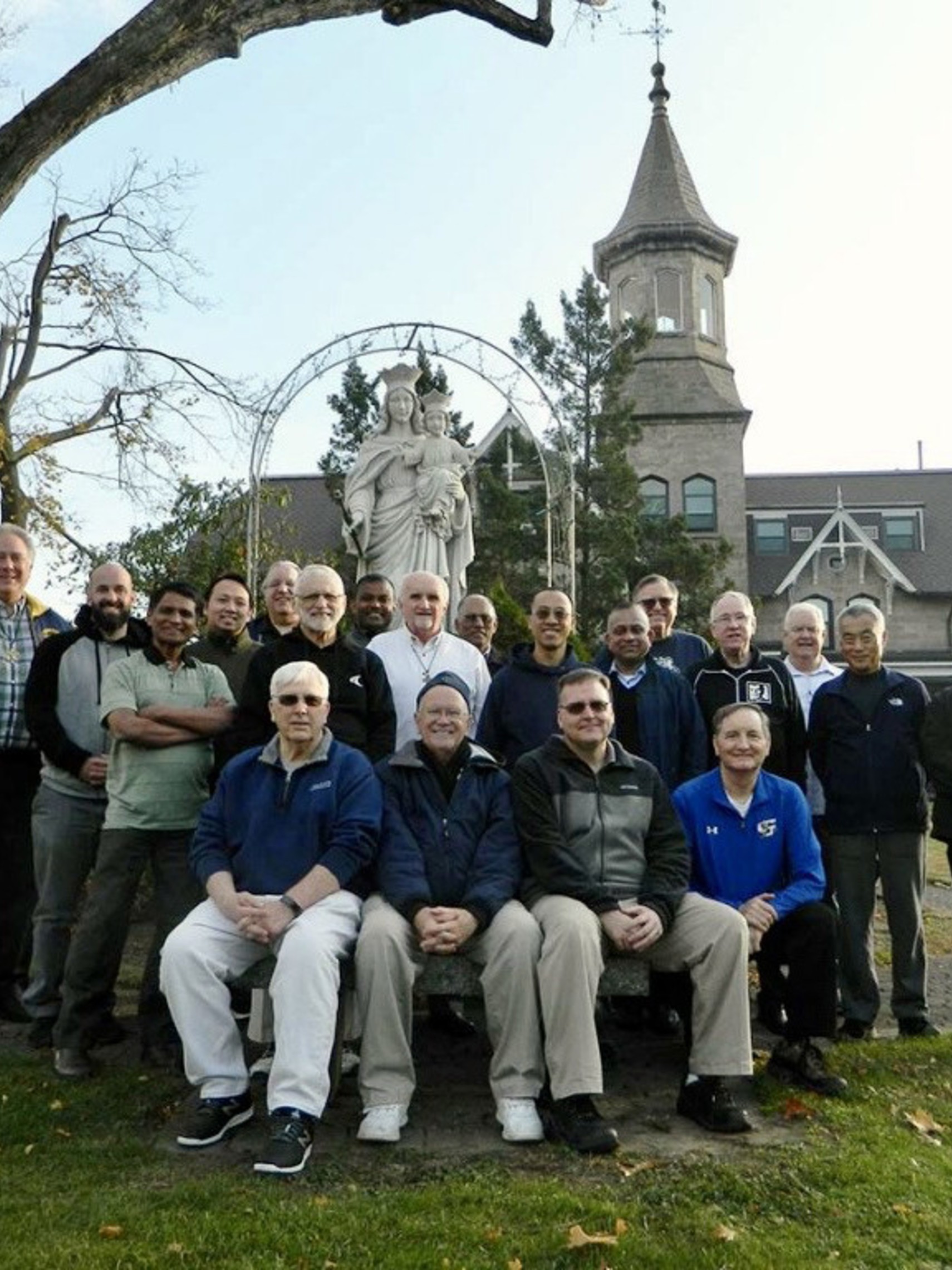 Salesians in front of the statue of Mary Help of Christians at the front of the Salesian Provincial Center in New Rochelle, NY