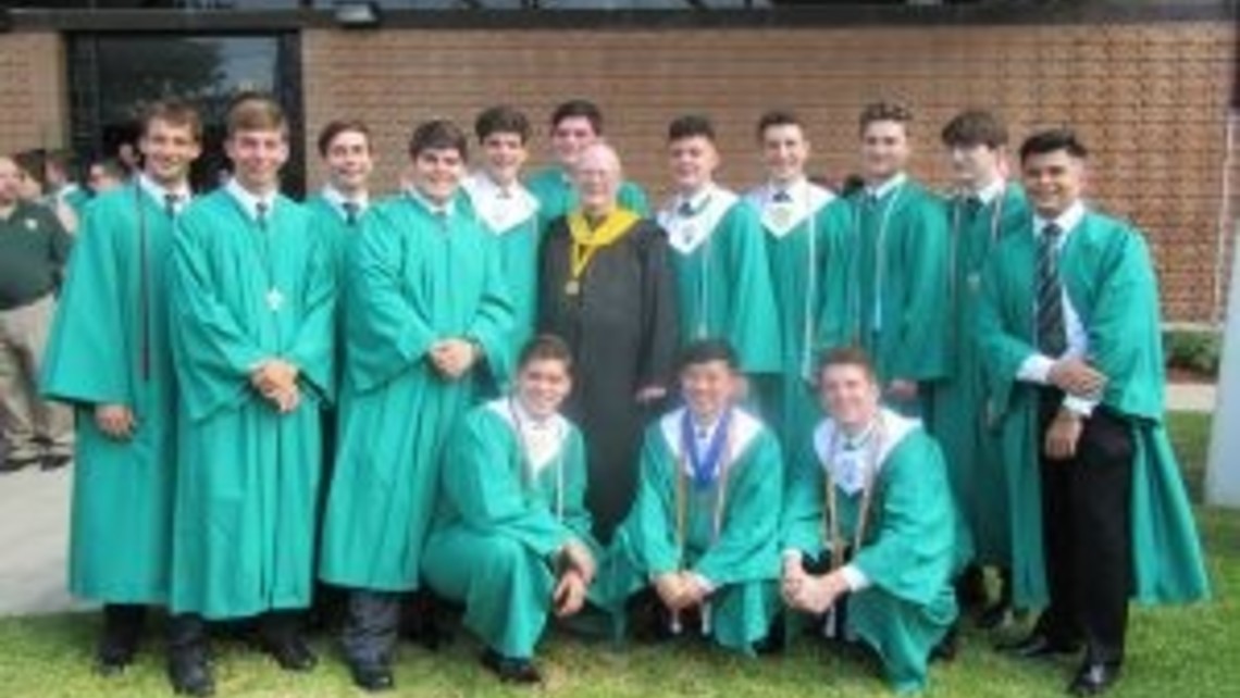 Bro. Jerry Meegan with a group of the graduating peer ministers after the baccalaureate Mass
