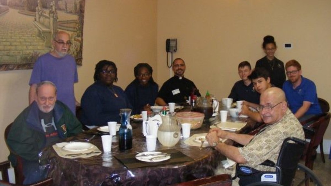 Fr. Abe at lunch with senior confreres, Mr. Lambert, and CRT students.