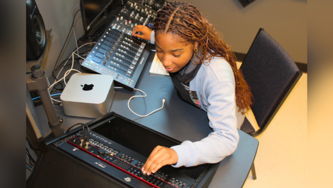 Kailey Washington ’26 tests out the sound system. | Credit: Sr. Boram Lee, FMA Marrero: AOL's New Podcast Recording Studio