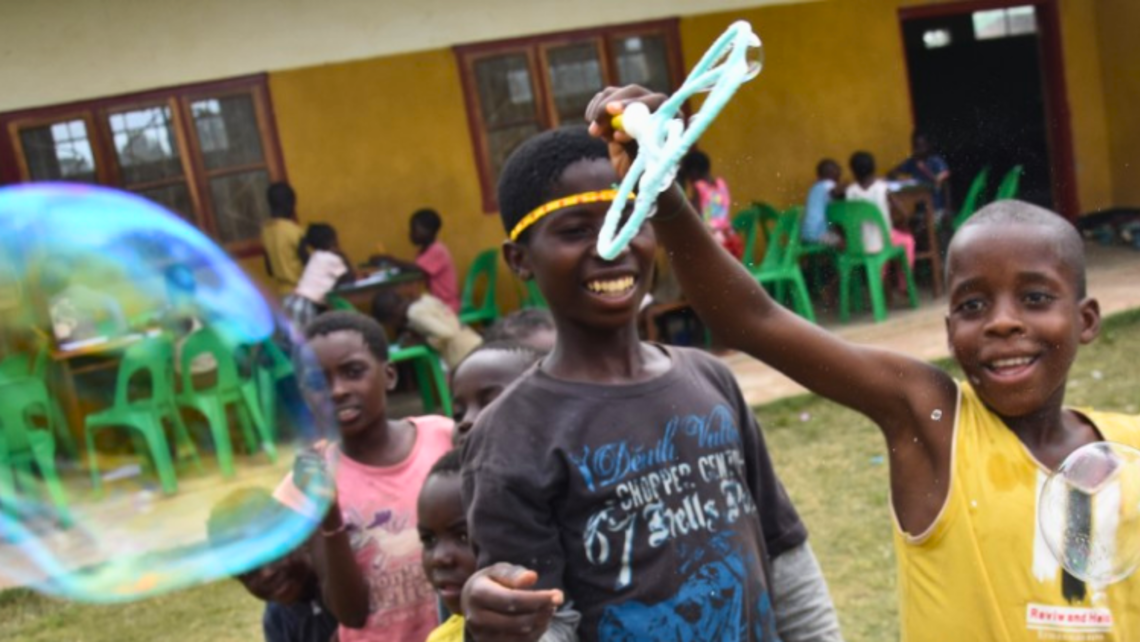 Youth at the oratory playing with bubbles and having a good time together