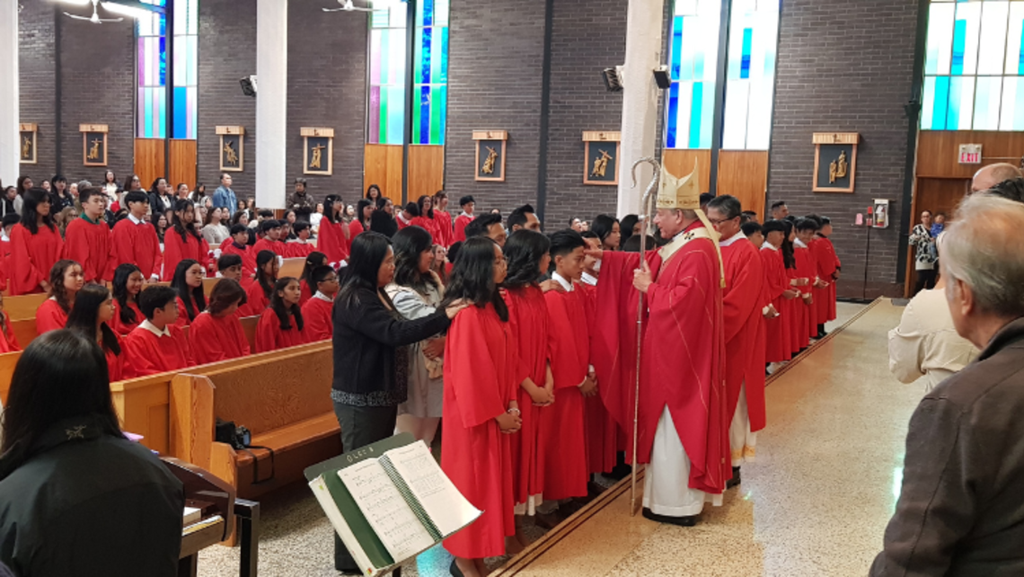 Archbishop Michael Miller, DD, confirms young people | Photo by Fr. Samson D. Antony, SDB Confirmation in Surrey