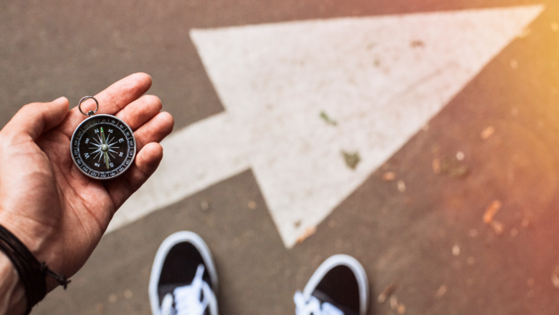 A man holds a compass and ponders where to go. | Courtesy of finwal from Getty Images Discernment Article