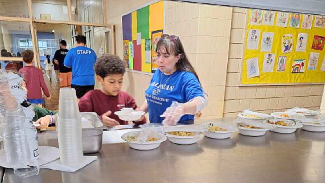 Staff and club members prepare mac and cheese meals. | Photo by Bro. Bob Metell, SDB East Boston: St. Francis and Mac and Cheese Meals