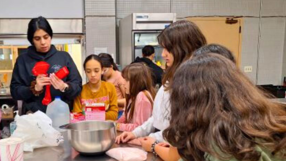 Brenda, the Boston Police Service Officer (left), conducts the baking class. | Photo by Br. Bob Metell, SDB East Boston: Vacation Camp