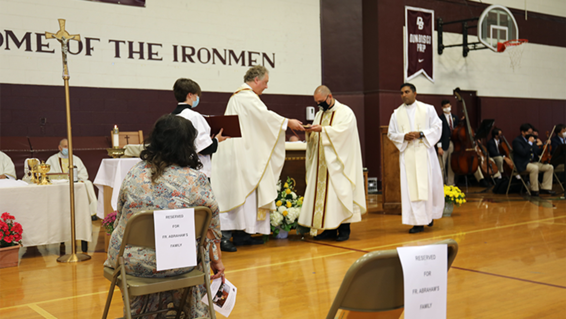 Fr. Abraham Feliciano, SDB receiving gifts from the Don Bosco Prep community during his installation as 22nd director of the school. | Photo by Jennifer Passerino Fr. Abe's Installation