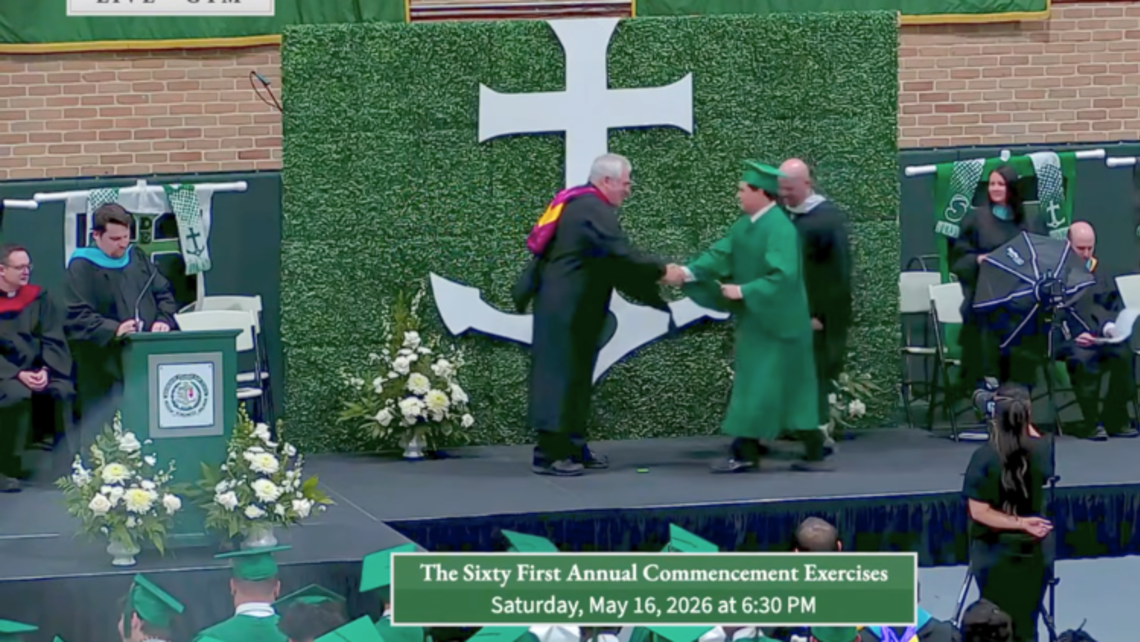 Fr. Steve Ryan, SDB, shakes the hand of a recent Shaw graduate. | Credit: Archbishop Shaw High School Graduations Pt. II