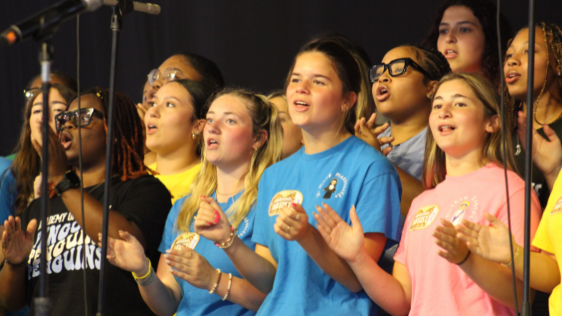 Academy of Our Lady's choir members perform on the stage of the Gospel Tent at the New Orleans Jazz and Heritage Festival on April 25, 2025. | Photo ©: Academy of Our Lady Marrero AOL Jazz Fest