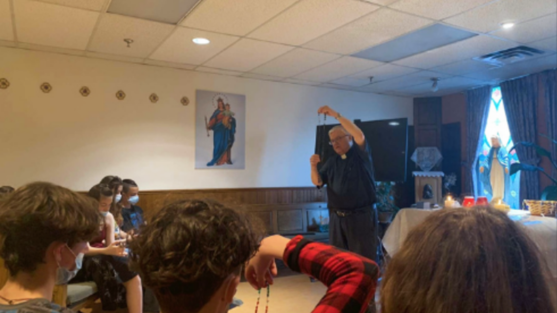 Fr. Richard Authier, SDB, and young people pray the Rosary during Faithspace | Photo by Fr. Richard Authier, SDB Mary on Wheel in Montreal
