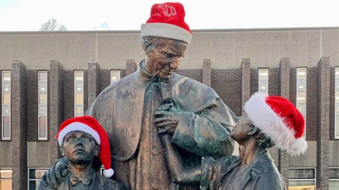 The statue of Don Bosco and his boys at Don Bosco Prep decked out in Santa hats | Photo by Brian Zawiski Message of the Provincial 12.22.22
