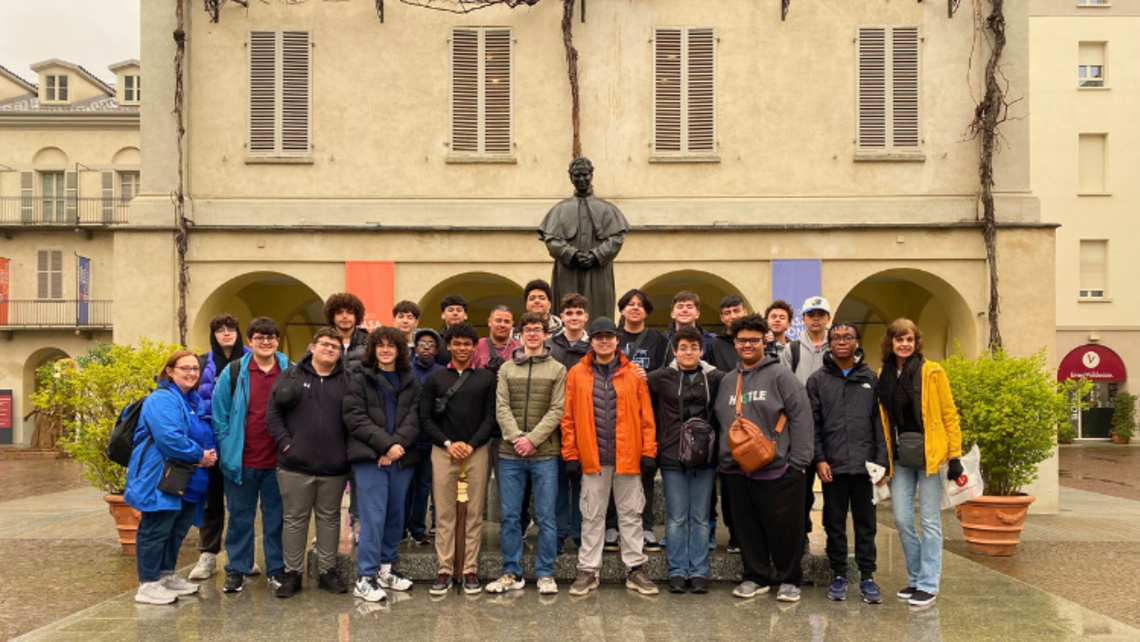 Salesian High students in front of the Don Bosco statue at the heart of Valdocco | Courtesy of Mr. Randy Taveras New Rochelle: Salesian High In Italy