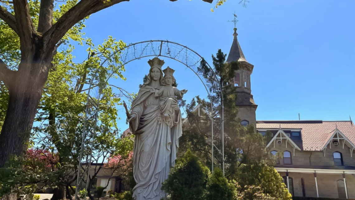 Statue of Mary Help of Christians with the front of the Salesian Provincial Center in the background | Photo by Ms. Julia St. Clair, Province Communications Director Provincial Center Job Openings