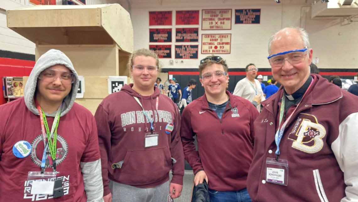 Fr. Lou Konopelski, SDB (right), with DBP robotics team members | Courtesy of Don Bosco Prep’s Facebook Ramsey: Robotics Competition Season
