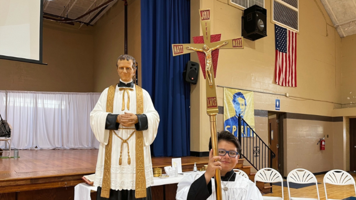 An altar server in front of the statue of St. John Bosco at Mary Help of Christians Center Tampa | Photo by Chioma Okoye Read This Week's Salesian News