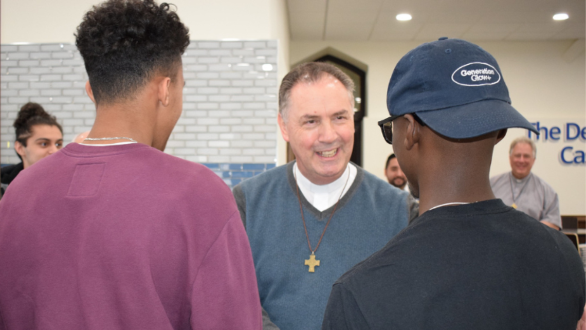 The Rector Major (center) greets two Salesian alumni during his visit in November 2022 | Photo by Salesian Youth Ministry SYM Corner 01.11.23