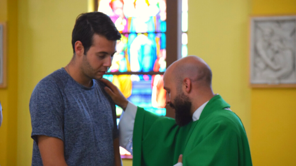 (from right to left) Fr. Steve DeMaio blesses a young adult at YAR | Photo by Salesian Youth Ministry SYM Corner 08.17.22