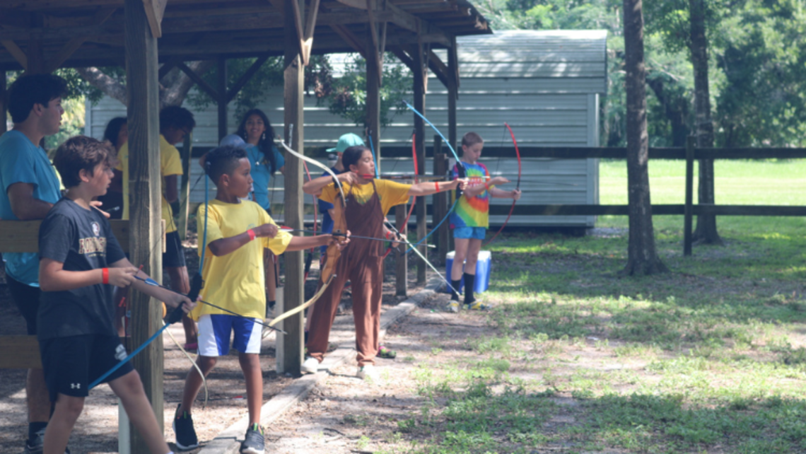 Campers prepare to shoot arrows during archery. | Credit: Ms. Chioma Okoye Tampa: Get To Know Camp Mary Help