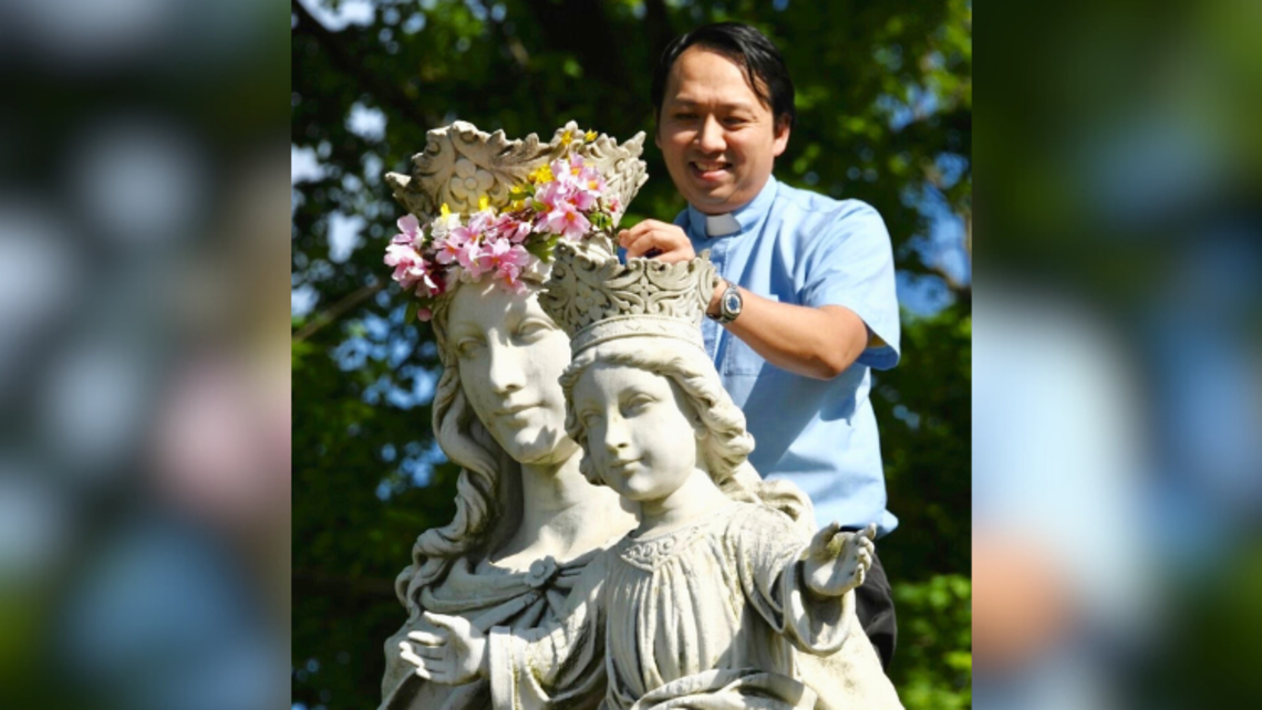 Fr. Paul Chu, SDB, places a crown on the statue of Mary Help of Christians outside the Salesian Provincial House in New Rochelle, NY | Photo courtesy of Mrs. Amy Stockinger Vocation Animation