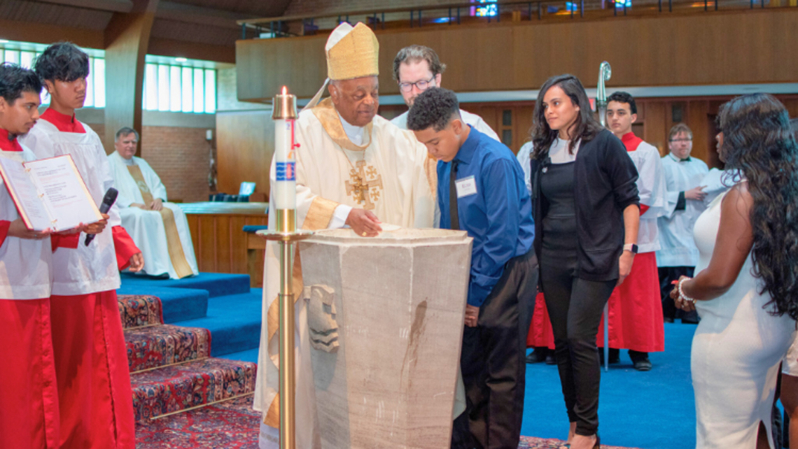 His Eminence, Cardinal Wilton Gregory, baptizes a RCIA student. | Photo by Ms. Kristen E. Beasley Washington RCIA