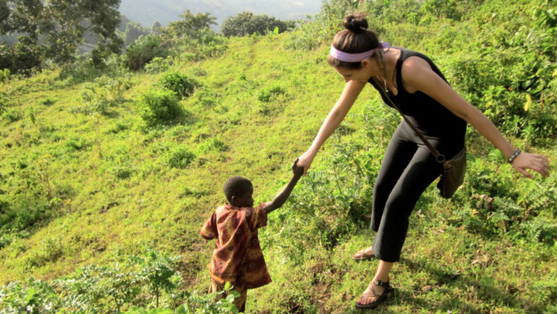 An SLM walks hand-in-hand with a small child. | Courtesy of Mr. Adam Rudin, Director, Salesian Lay Missioners (SLM) Program Weekly Prayer 10.17.24