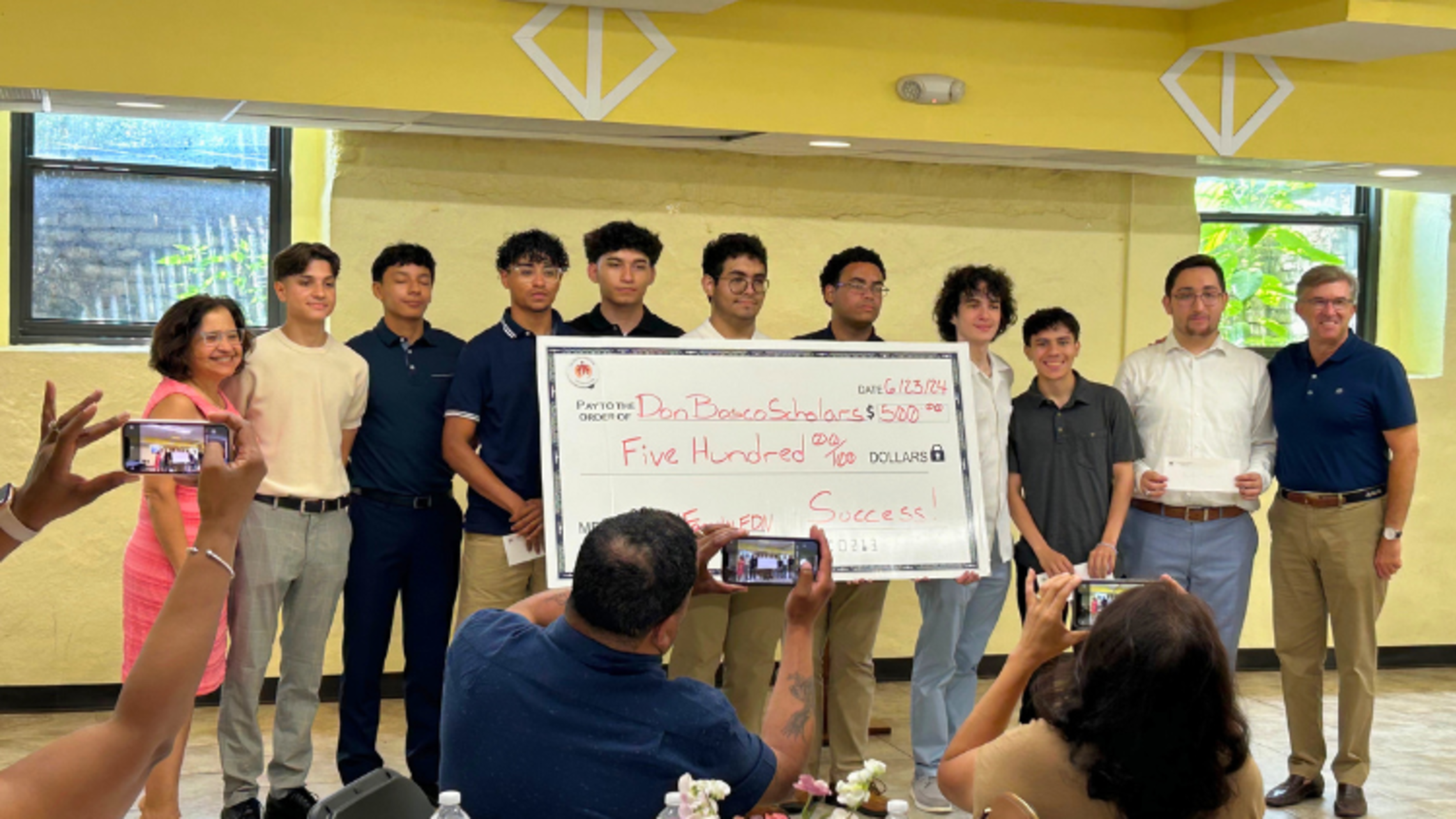 Don Bosco Scholars pose with a $500 check. | Photo by Mr. Andres Alvarez  Don Bosco Scholars