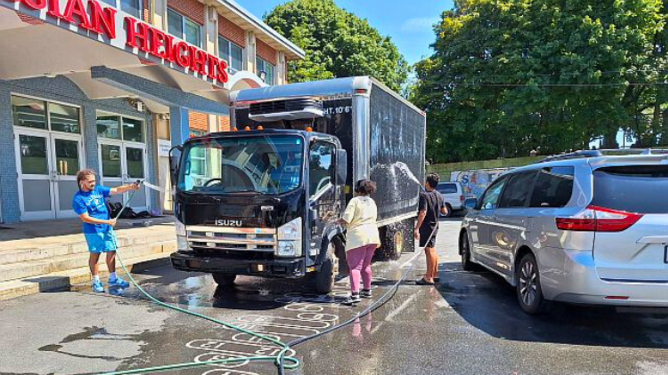 Teens at the Club wash a delivery truck. | Credit: Bro. Bob Metell, SDB East Boston Car Wash