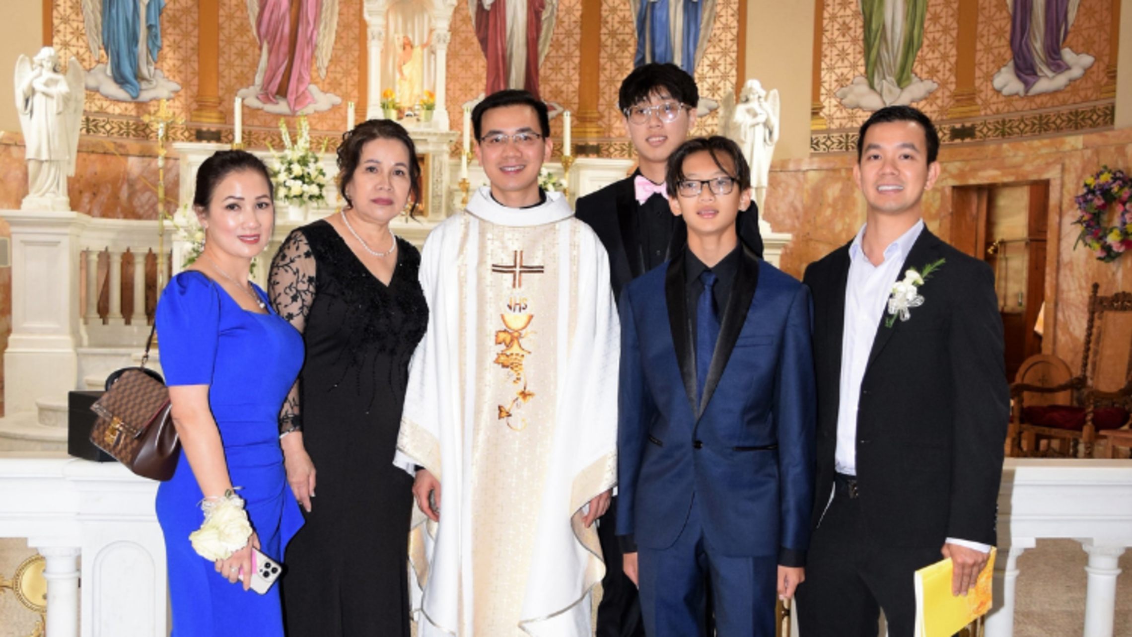 Newly ordained Fr. Ky Nguyen, SDB, and his family