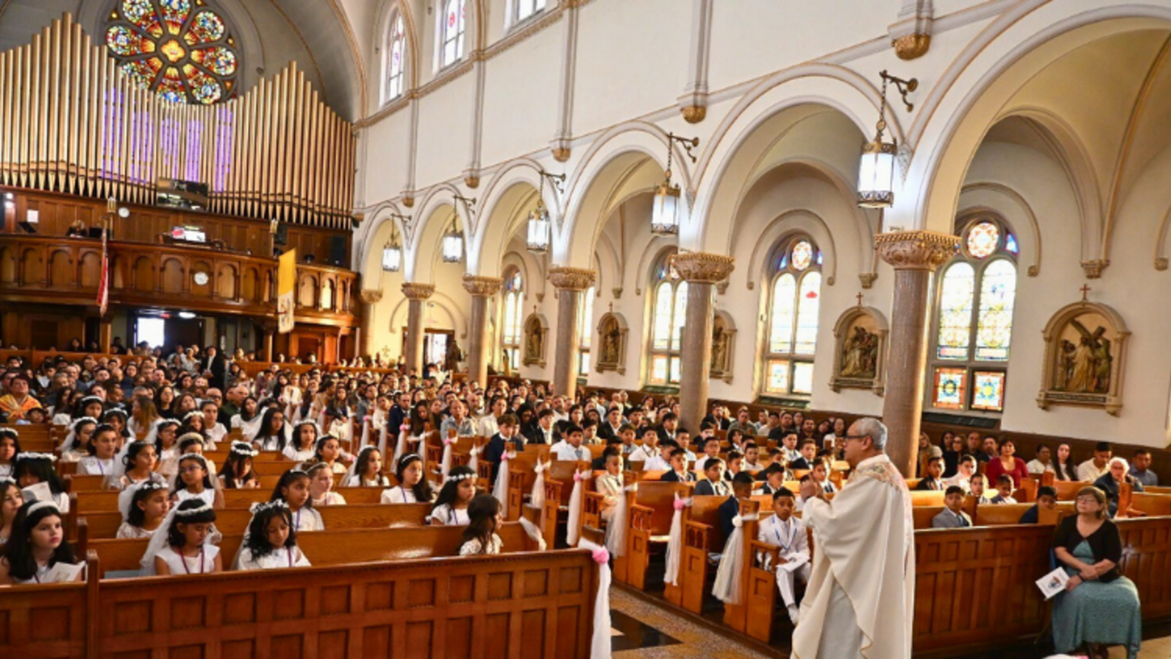 St. John Bosco Parish’s Pastor Fr. Franco Pinto, SDB, speaks to the first communicants. | Credit: Fr. Eddie Chincha, SDB Port Chester: First Communions