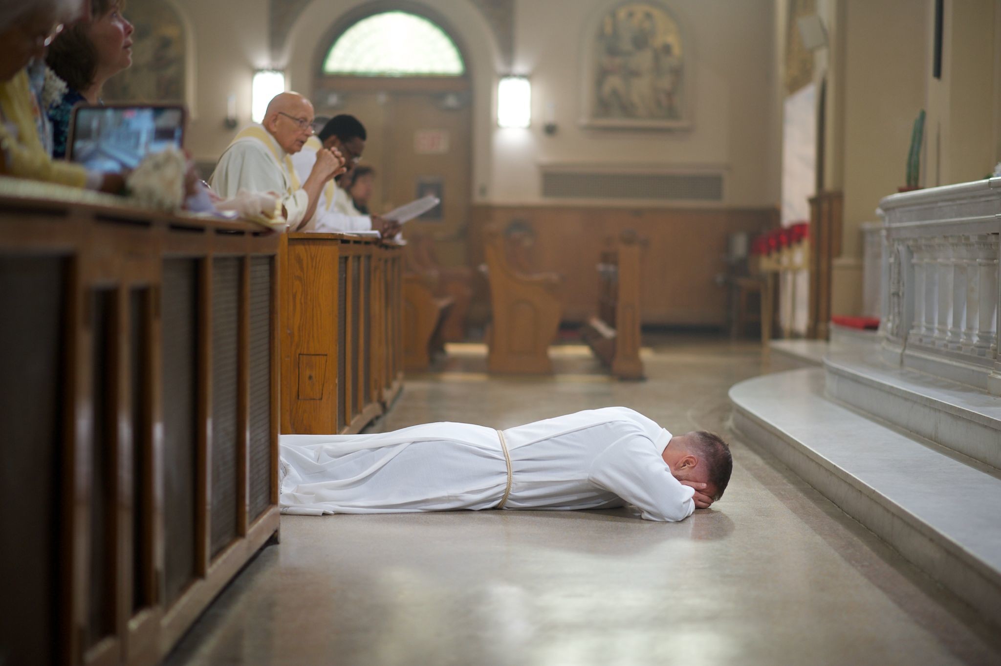 Dcn. Tom Junis, SDB, lies in prostration during his ordination. Photo by Vicky